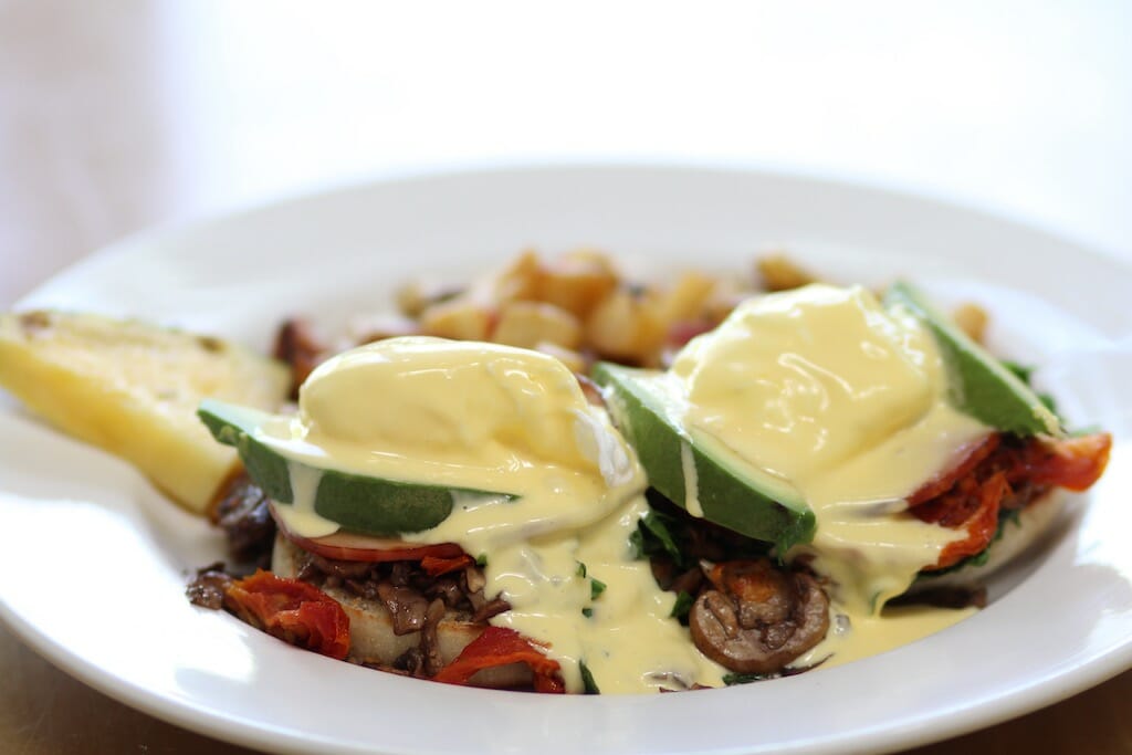 Beautiful hollandaise blanket over poached eggs, peppers and the rest of the mexican inspired eggs benedict