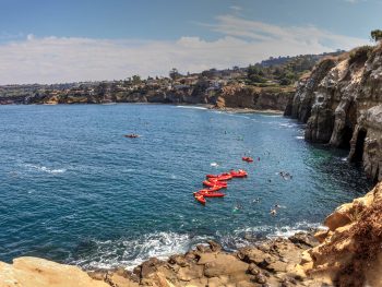 kayaks in the water near sand stone cliffs in La Jolla california - San Diego Valentine's Day
