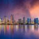 San Diego Skyline reflecting in the water at sunset with purple and pink sky