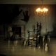Disturbing shadows going over an otherwise empty room with a rocking chair and shining light