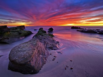 Amazing sunset lights up Windansea Beach in La Jolla, San Diego, California