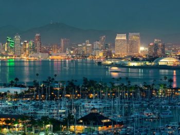 San Diego downtown skyline at night with boat in harbor.