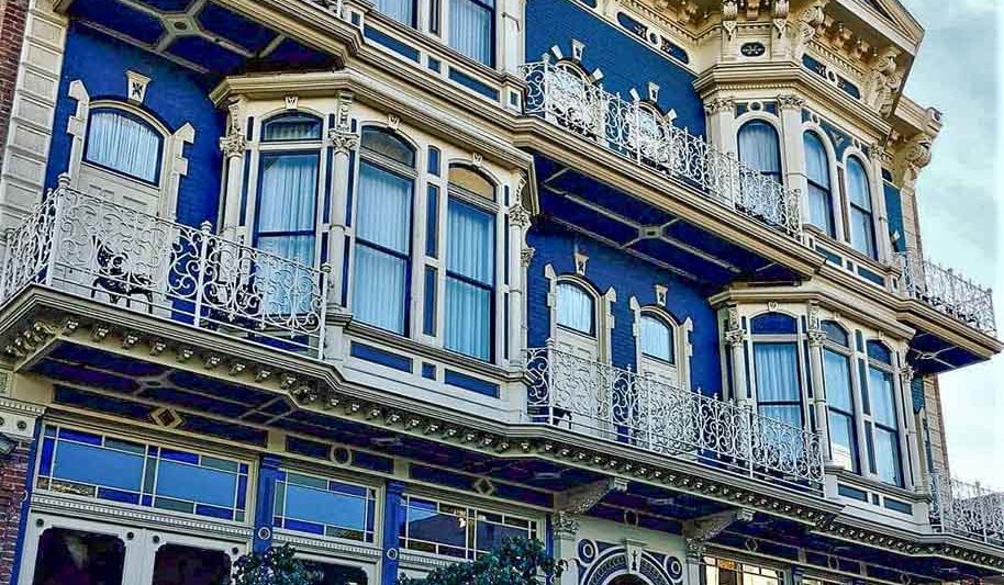 Facade of Horton Grand Hotel in San Diego - Victorian style building with white stucco and blue paint