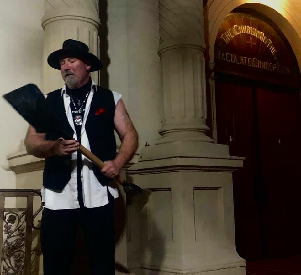 Guide of the ghost tour old town wearing black pants and black vest with white shirt