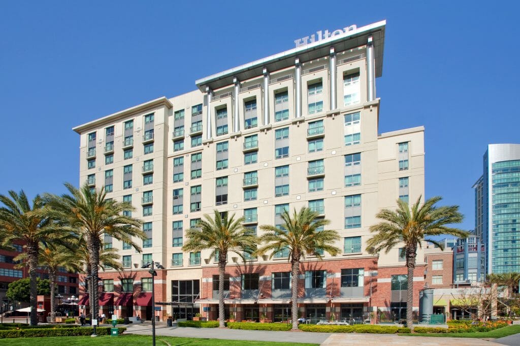 Hilton hotel in the Gaslamp Quarter, San Diego. White building with palm trees in front