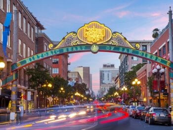 Decorative and lid up street sign over 5th avenue in the Gaslamp Quarter San Diego