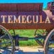 Historic, rusty railway cart with Temecula etched into the side