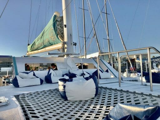 Front hull of Triton Catamaran San Diego with netted floor and blue and white bean bag seats