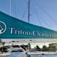 Teal sail with white writing: Triton Charter - San Diego Catamaran Cruise