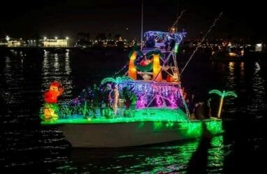 boat decorated with lights and palm trees blow up figures