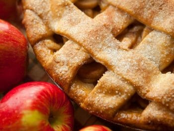 Lattice crust apple pie with whole apples in the bottom corner - Best Apple Pie Bakeries Julian