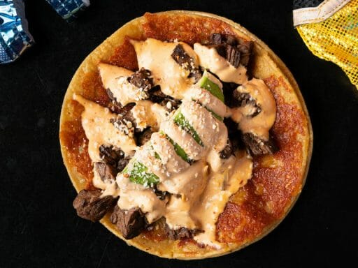 Flatlay shot of queso taco on a black table at Lucha Libre