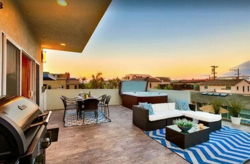 rooftop patio with lounge sofa, dinig table, BBQ and hot tub