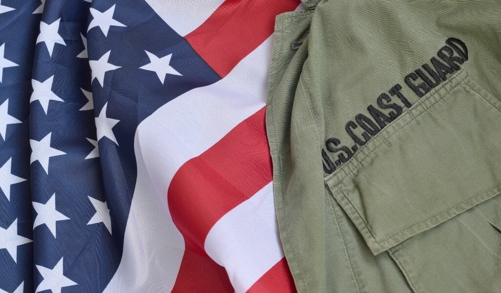 Flatlay of US Flag with olive colored uniform with black lettering: US Coast Guard