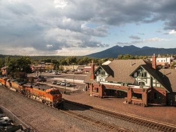 Aerial View of Flagstaff Train station / Flagstaff visitor center and a fright train passing by in front of it.