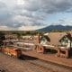 Aerial View of Flagstaff Train station / Flagstaff visitor center and a fright train passing by in front of it.