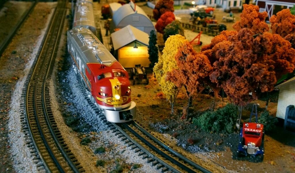 model railroad set with train and a "fall" scene with small village and fall foilage