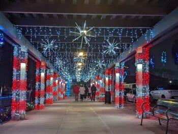 Covered walkway decorated with red and white lights and stars for the Holidays