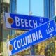 San Diego Street Signs on the Corner of Beech Street and Columbia in front of glass building