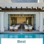 Pool in the foreground - Mexican style white building in the background - white textoverlay over pool: Best Boutique Hotels in Palm Springs