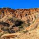 orange sandstone cliffs at Torrey Pines Beach Trail with dark blue sky and the trail in the foreground