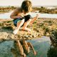 Boy looking at tide pools on rocky ocean shoreline. San Diego tide pools. Tide pools San Diego.