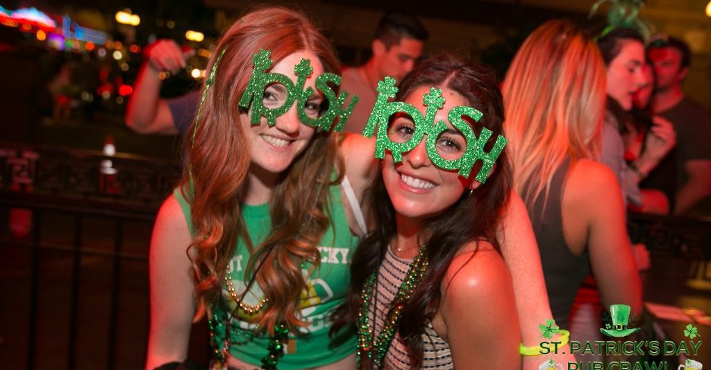 two young women at a party with green St Patricks Day Accessories