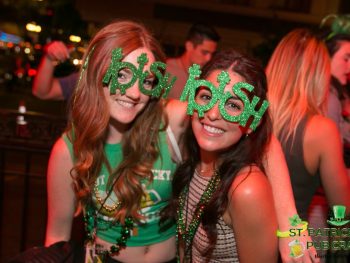 two young women at a party with green St Patricks Day Accessories