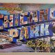 Wall mural painted like a postcard reading "Greetings from Chicano Park San Diego, Co. A National Historic Landmark". Chicano Park murals, Barrio Logan.