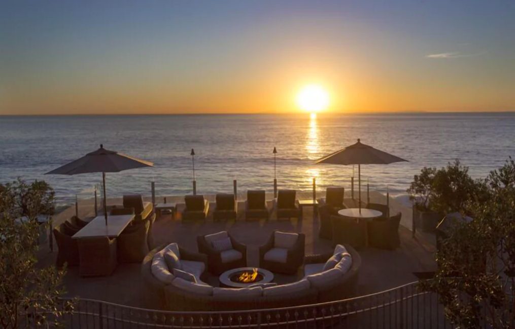 Large patio overlooking Pacific Ocean at sunset. Laguna Beach vacation rentals ocean view.