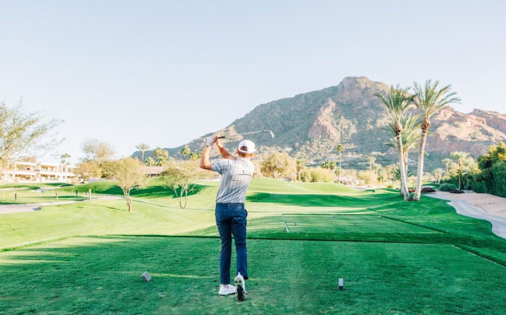 Man golfing at the Short Course in Scottsdale with Camelback Mountain in the Background - Mountain Shadows Resort Scottsdale