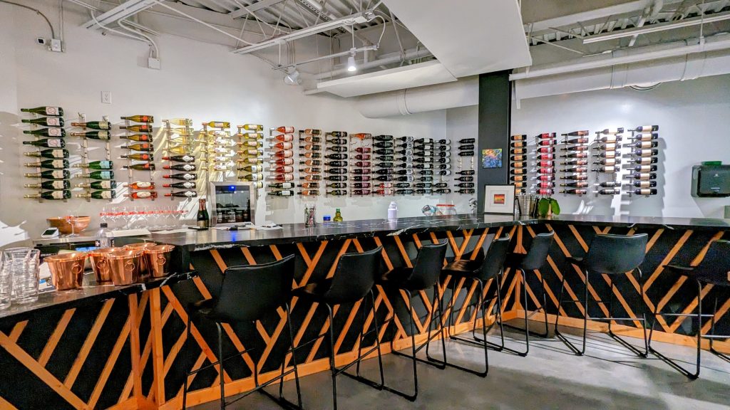 Bar and wine bottles on white wall at the Wine collective Scottsdale