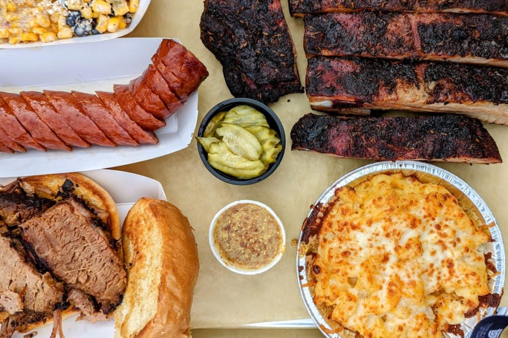 Flatlay BBQ meats with sides - Julian Restaurants