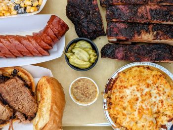 Flatlay BBQ meats with sides - Julian Restaurants