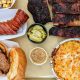 Flatlay BBQ meats with sides - Julian Restaurants