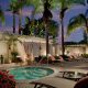 Nighttime shot of hot tub and pool area with lounge chairs and palm trees. Loews Coronado Bay Resort.