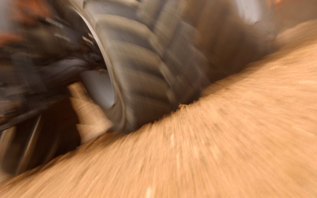 Closeup of a monster truck wheel on sand