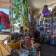 inside of Libelula Bookshop in Barrio Logan with display tables and shelves full of books