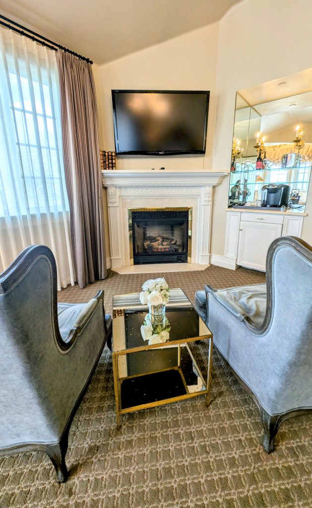Fireplace with 2 chairs and tv in my room at The Genevieve Hotel Santa Ynez