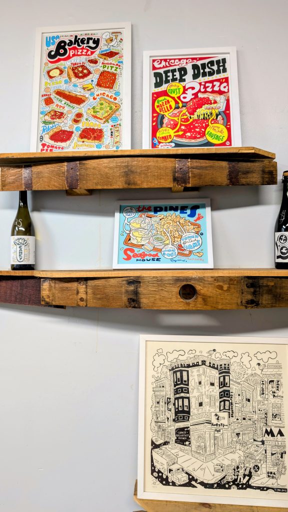 Shelves with wine bottles and art work at Kings Carey Wines