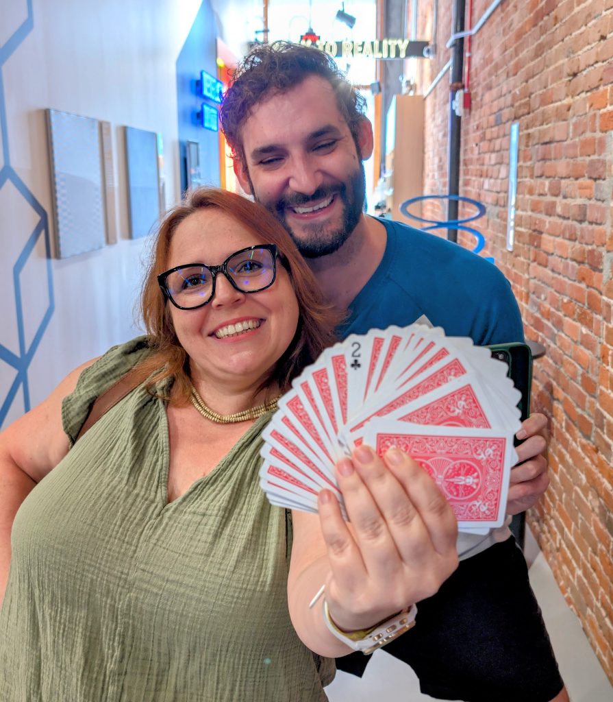 Andrew and Maria holding deck of cards during a card trick