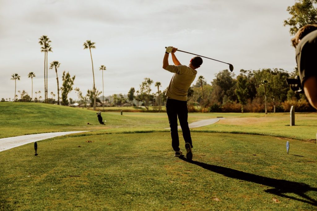 Man swinging golf club at La Valle Coastal Club