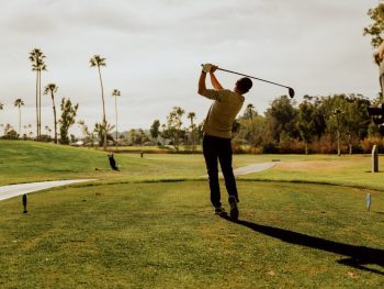 Man swinging golf club at La Valle Coastal Club