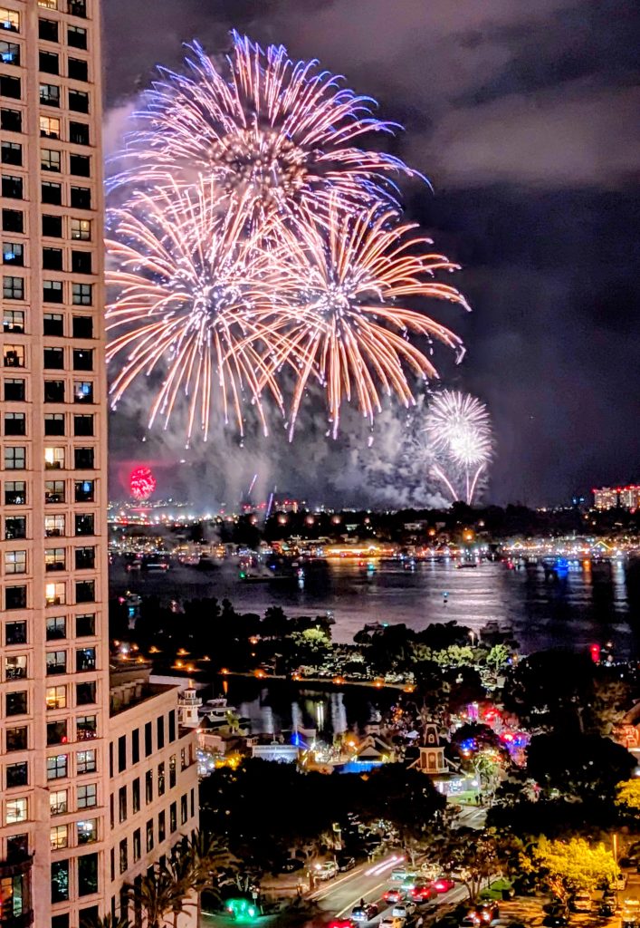 Large fireworks during Big Boom Bay in San Diego 4th of July Celebration next to Grand Hyatt Hotel by Seaport Village