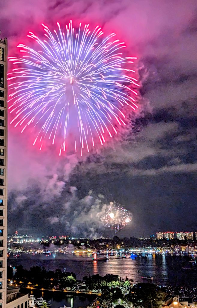 Big pink firework on 4th of July in San Diego over San Diego Bay. 