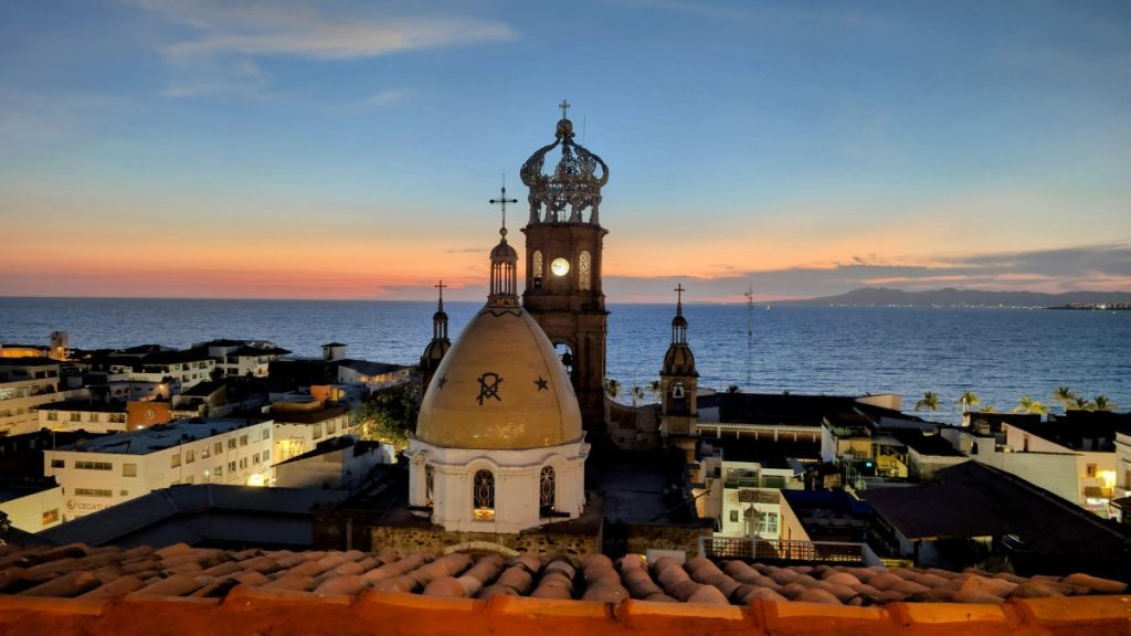 View from La Capella restaurant in Puerto Vallarta over cathedral and ocean during sunset