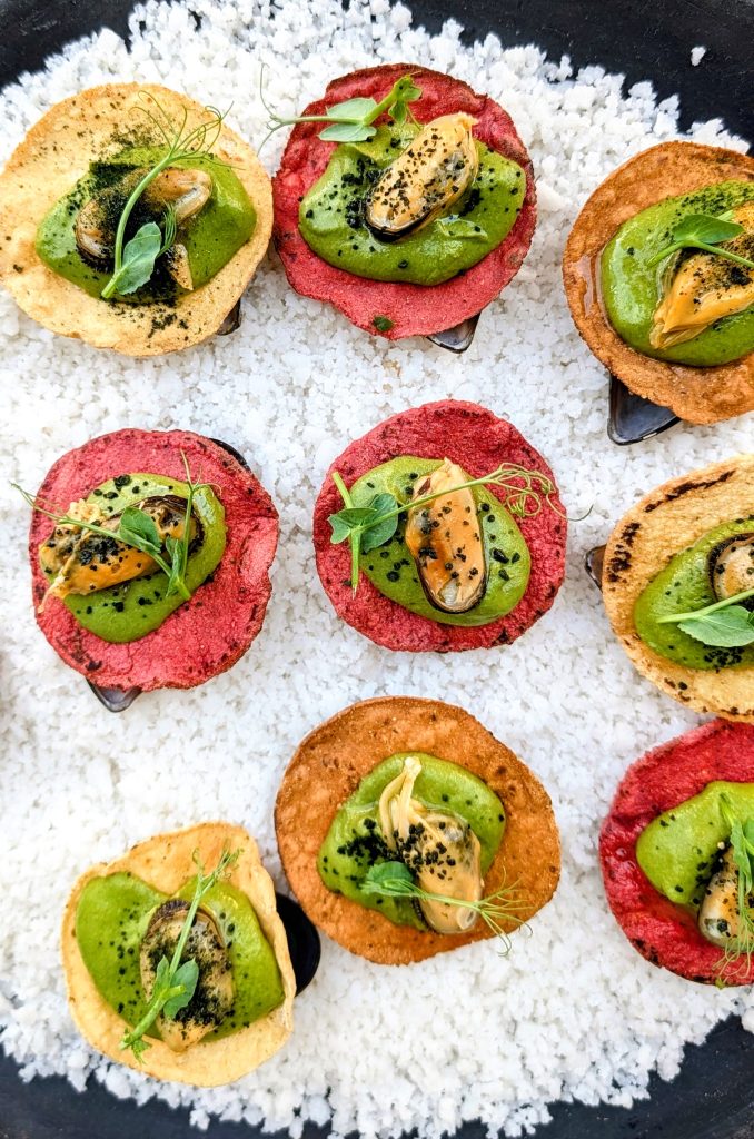 mussel tostada on colorful corn tostadas